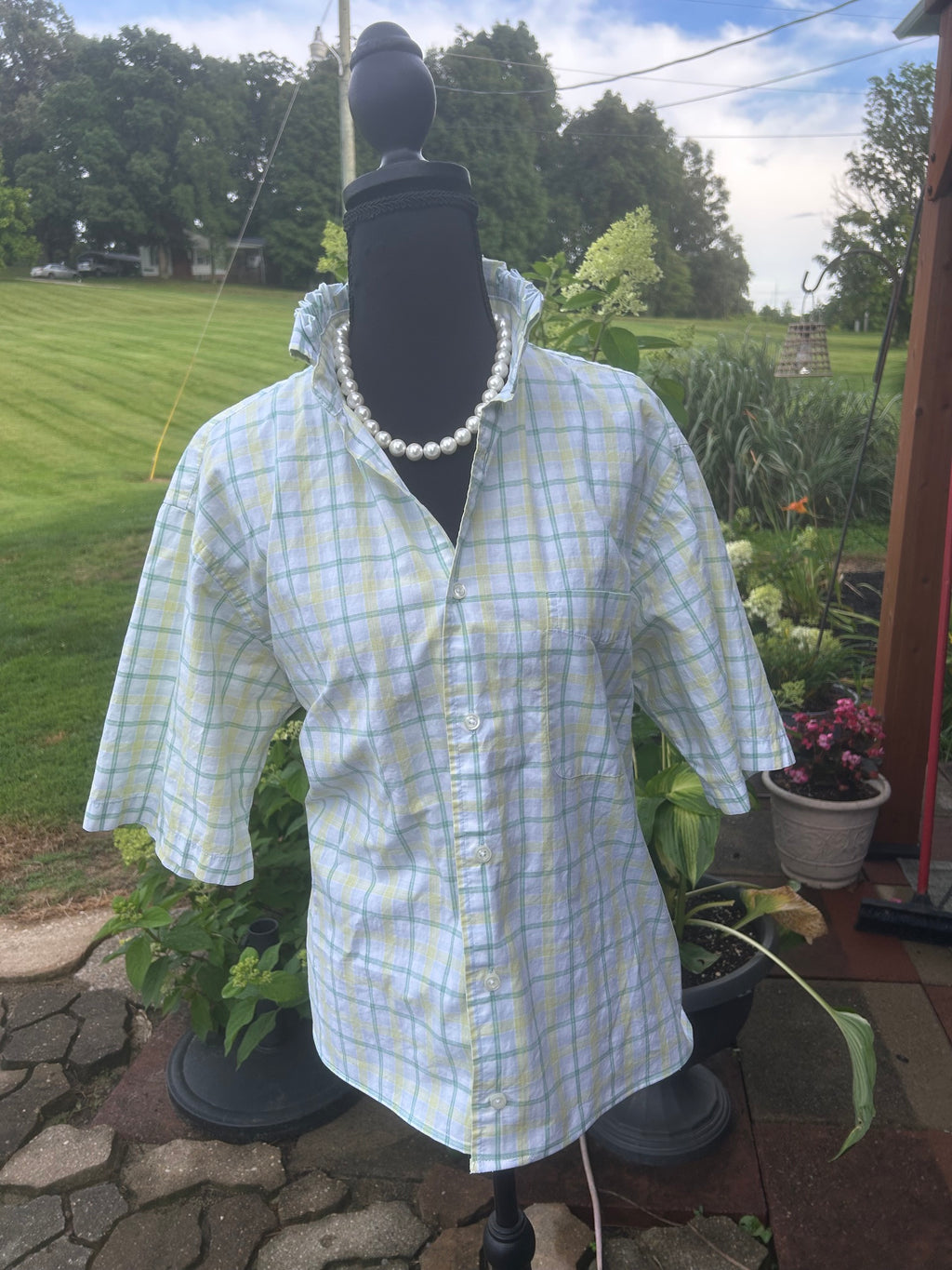 White blouse with soft shades of pale yellow and green.