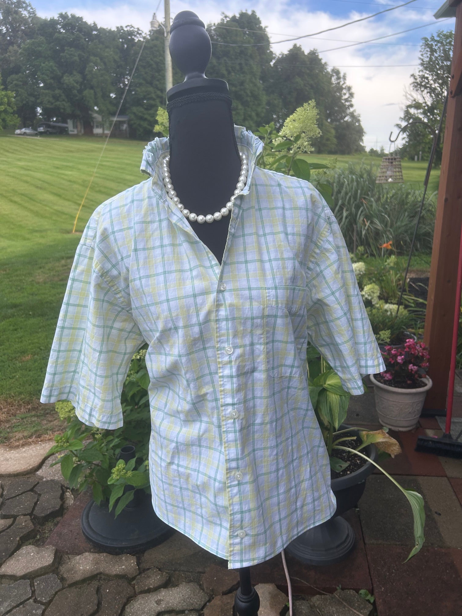 White blouse with soft shades of pale yellow and green.