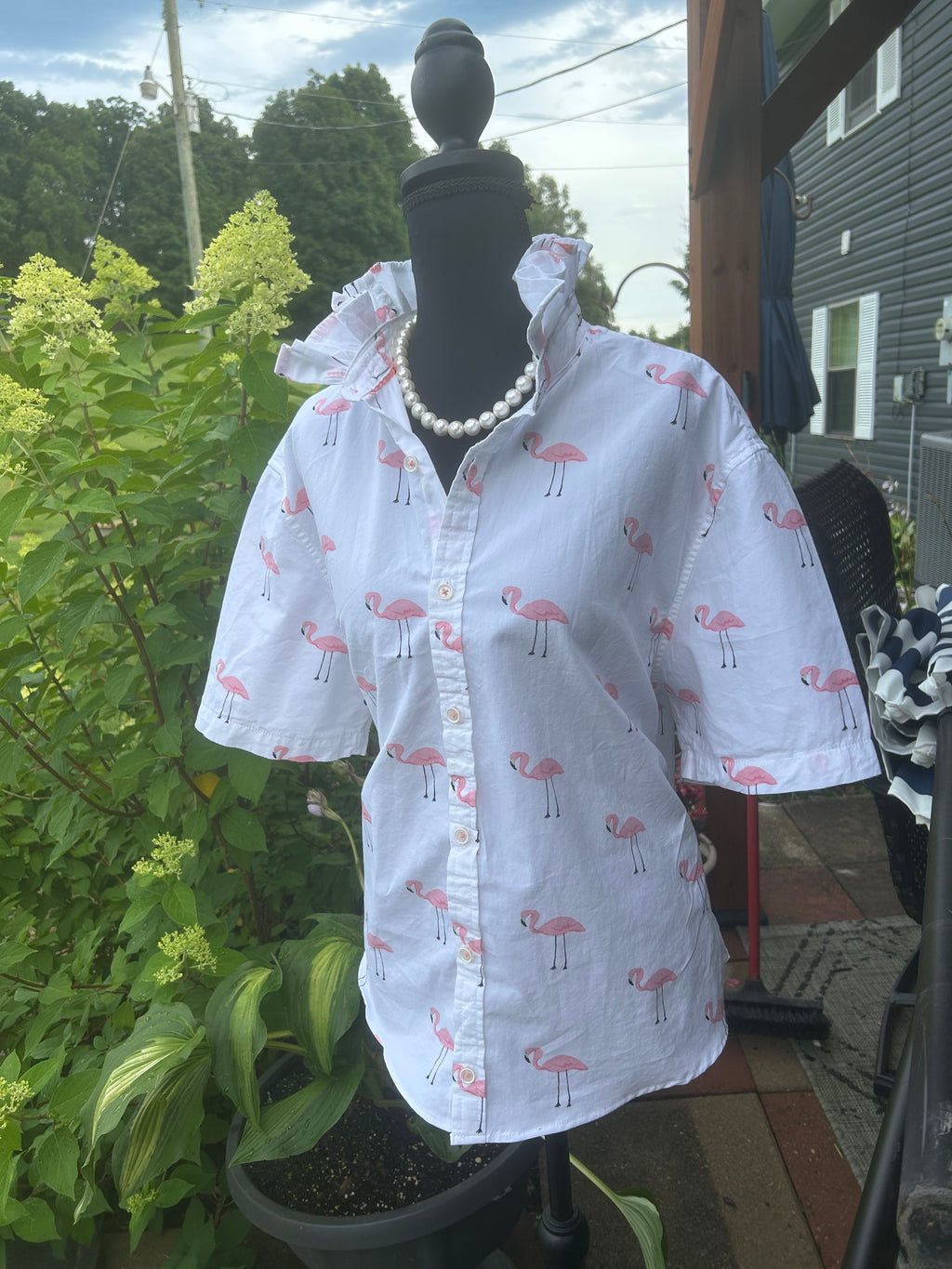 Playful pink flamingo print with a signature ruffled collar