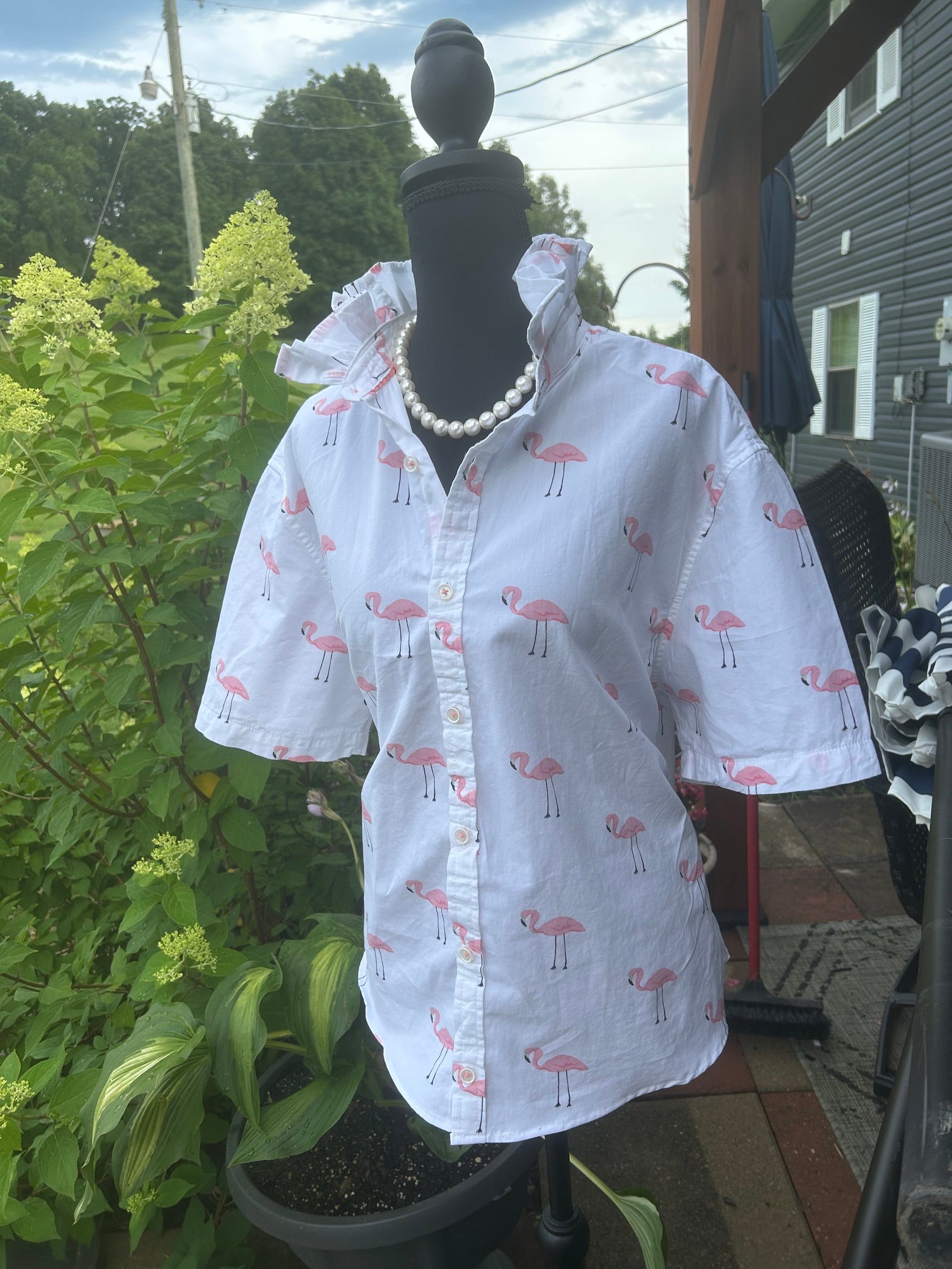 Playful pink flamingo print with a signature ruffled collar