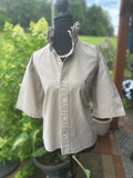 Classic short sleeve button-down with elevated feminine ruffled collar